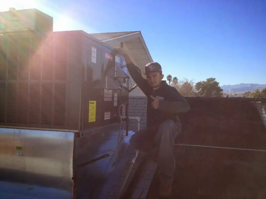 HVAC technician performing HVAC Inspection on a rooftop unit in Rosemead
